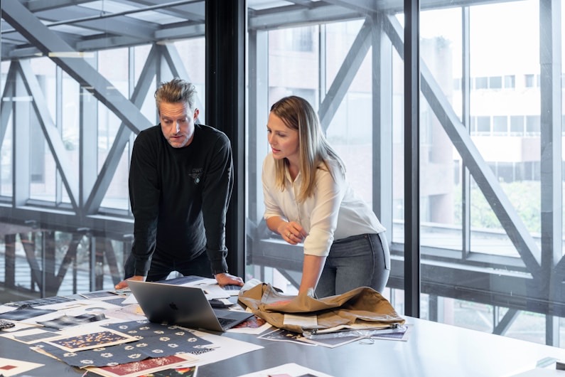 Two colleagues reviewing plans at a desk