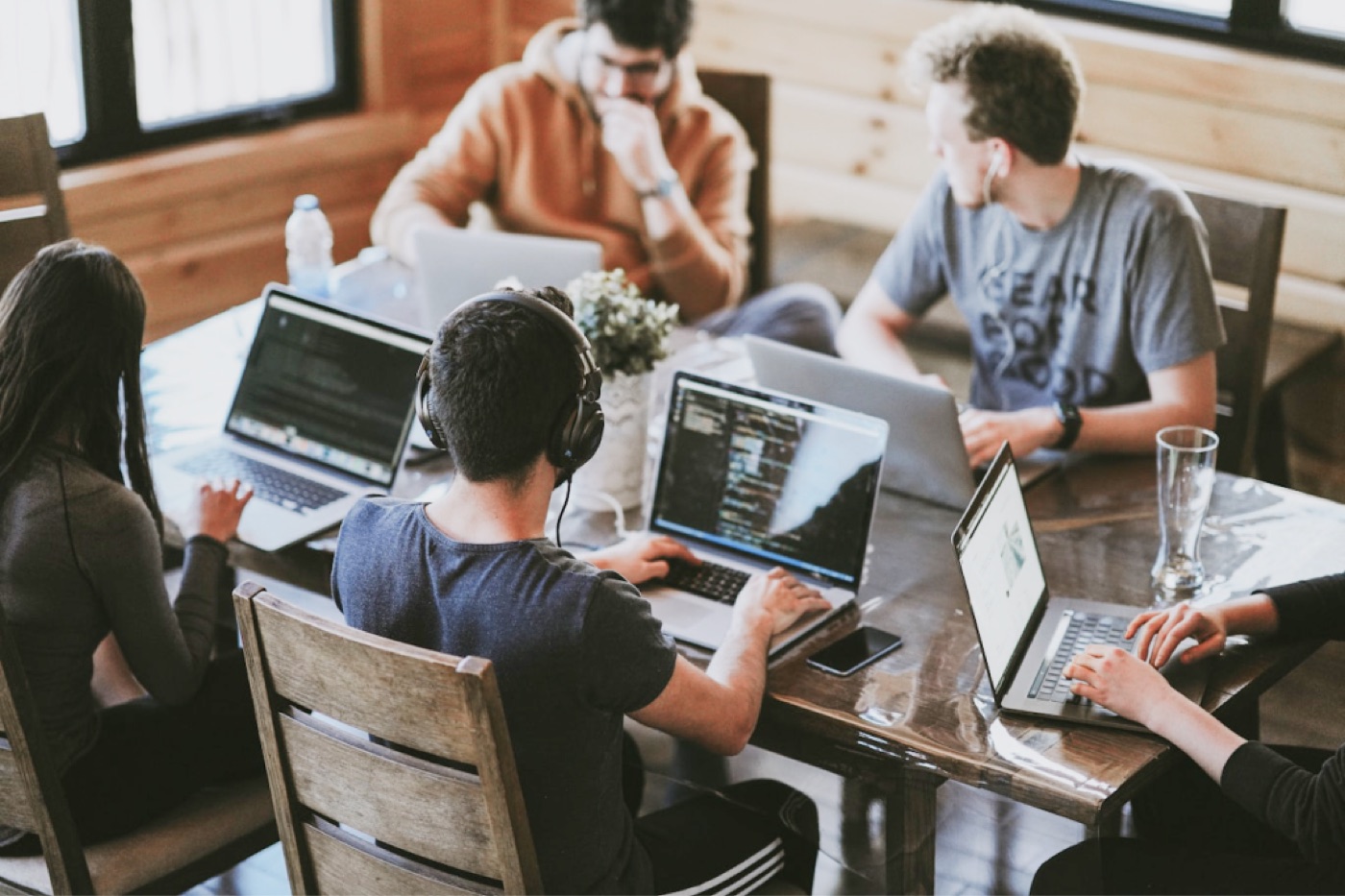 A team working together around laptops