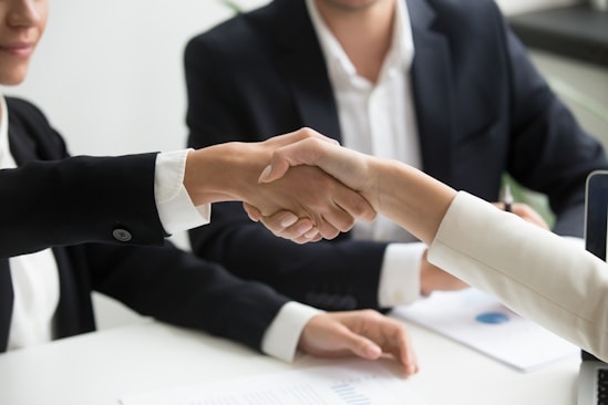 A handshake across a desk