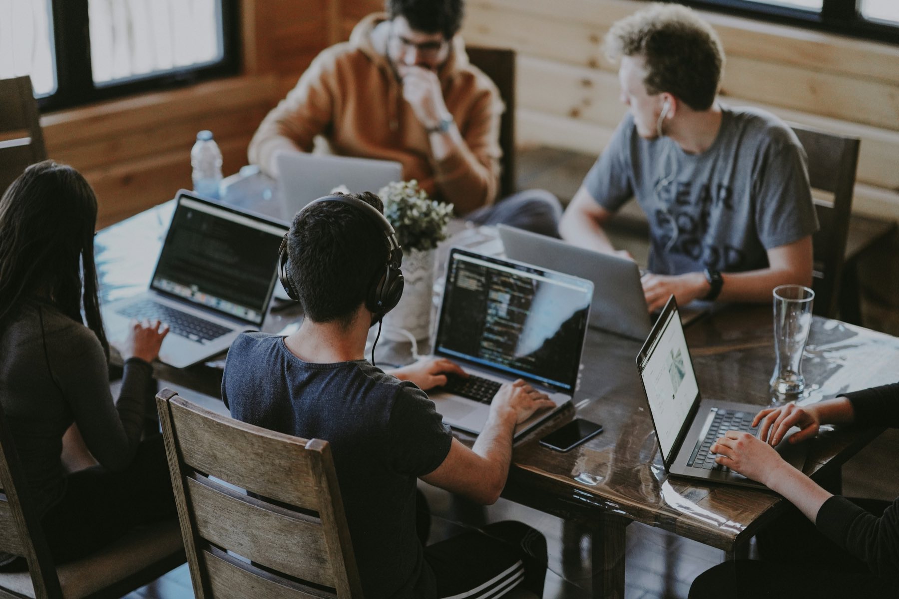 Advisers working together over laptops in a meeting